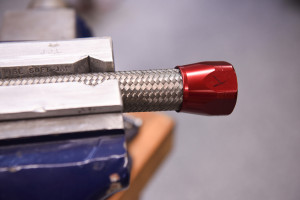 Clamp braided stainless hose into AN vise jaw inserts